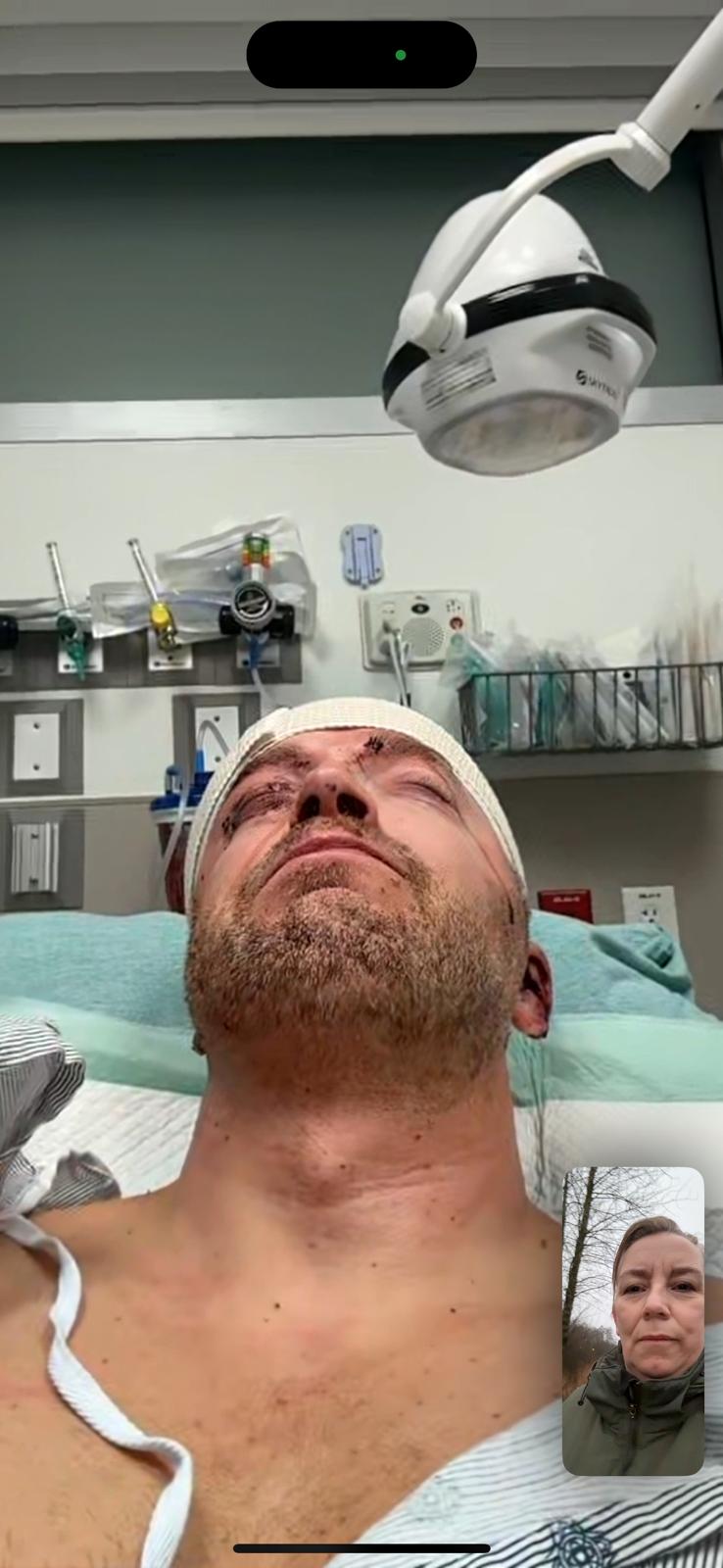 A person lying in a hospital bed Description automatically generated